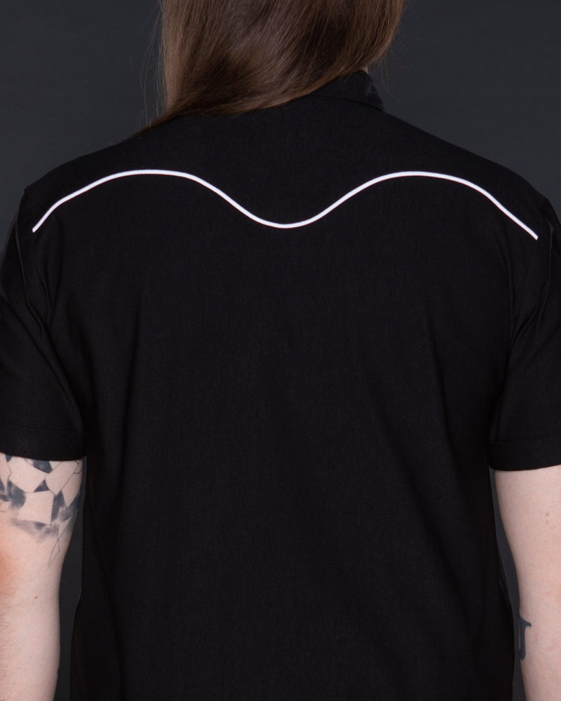 Classic black Johnny Western Shirt in premium soft Bengaline fabric, featuring a tailored fit, crisp collar, and unique western detailing. Accented with eye-catching white snap buttons, delicate minimalist piping, and a subtle rose pattern, this versatile shirt is a timeless addition to any wardrobe, suitable for casual wear, smart-casual ensembles, and layering with jackets or vests.