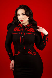 A black/red June Dress made from stretch bengaline, featuring long piped sleeves with faux snap cuffs, fixed front snaps for a seamless and polished look, and exquisite rose and thorn embroidery on the collar, cuffs, bust, and hips, perfect for women seeking a dark Western-inspired dress that combines elegance and edgy spring style.