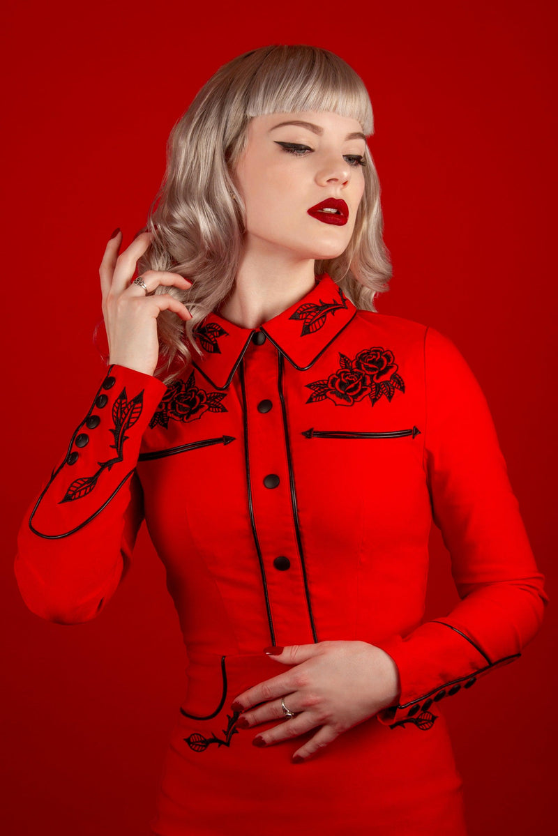 A darkly romantic red dress designed by Katakomb, the June Dress is made from high-quality stretch bengaline fabric that enhances comfort and shape. Featuring embroidery of roses and thorns on key areas, piped detailing, and faux snap cuffs, it delivers a vintage western-inspired look with modern gothic elegance.