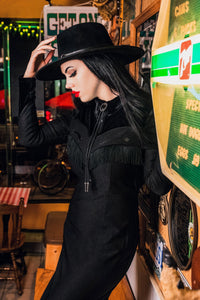 The black Loretta Dress by Katakomb is a carefully handmade statement piece, featuring a playful cheeky fringe, arrow detailing along the bust, pleather yoke accents, and rich faux velvet panels, all created from high-quality bengaline fabric for a stylish, comfortable, and Western-inspired outfit.