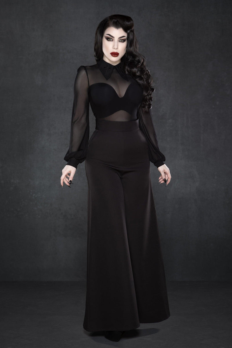 High-waisted Palazzo pants in classic black, featuring a flattering wide-leg silhouette inspired by 1940s fashion, crafted from lightweight crepe fabric with a touch of stretch for ease of movement, complete with two functional front pockets, making them perfect for versatile styling from workdays to casual evenings.