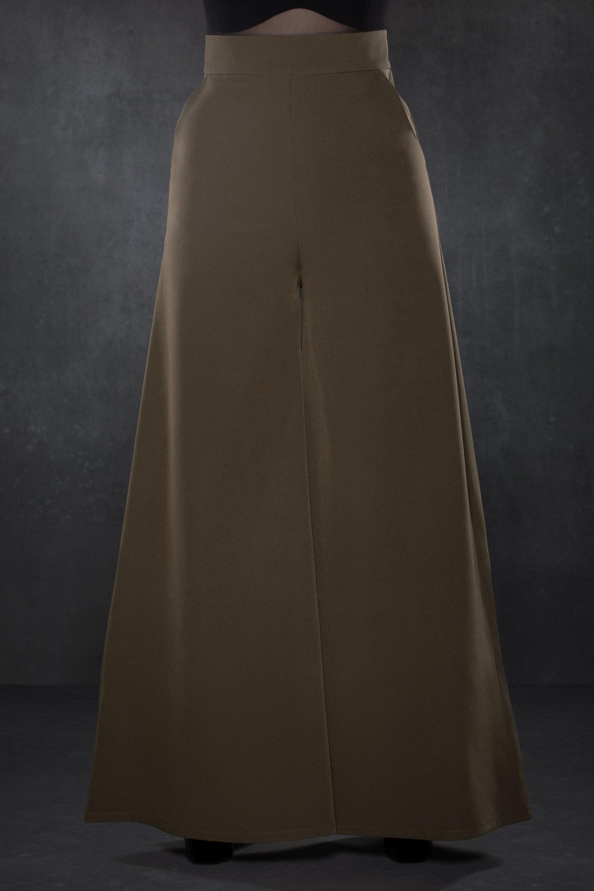 Chic olive green high-waisted Palazzo pants with a vintage-inspired wide-leg silhouette, crafted from lightweight crepe fabric with slight stretch for movement, featuring two working front pockets, perfect for creating a sophisticated yet relaxed outfit suitable for both professional and social settings.