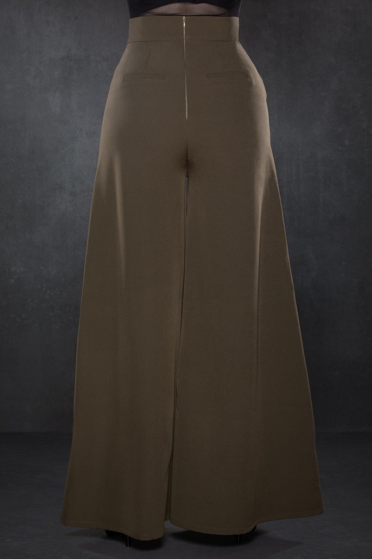 Versatile olive green Palazzo pants with a vintage 1940s-inspired wide-leg silhouette, crafted from lightweight crepe fabric with subtle stretch, designed with a high-rise waist and two working front pockets, offering a timeless, flattering fit suitable for office wear, casual brunches, or evening occasions.