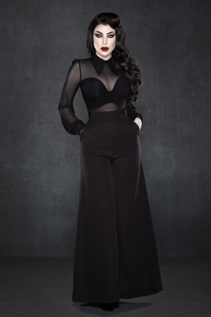 Black wide-leg Palazzo pants with a high-rise waist and chic 1940s-inspired design, made from lightweight crepe fabric with minimal stretch, featuring practical front pockets and a flowing silhouette, perfect for dressing up with heels or pairing with casual tops for a stylish day-to-night look.