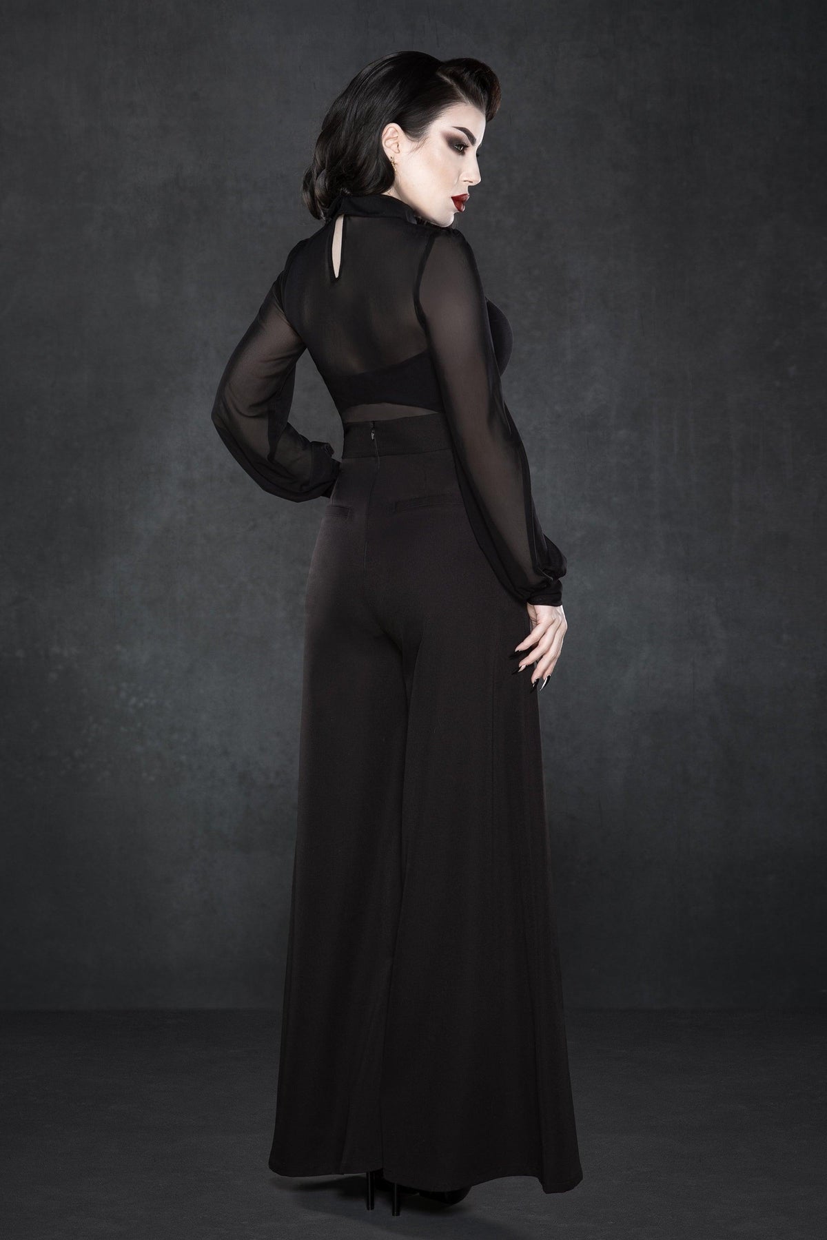 Black crepe Palazzo pants with a high waist and relaxed wide-leg silhouette, inspired by classic 1940s fashion, made from soft, slightly stretchy fabric, designed with two functional front pockets, offering a versatile and flattering fit suitable for work, casual outings, or weekend brunches.