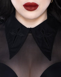 Personal Jesus long-sleeve mesh top featuring soft see-through fabric, oversized embroidered cross patches on an extended pointed collar, a subtle keyhole back for added allure, and stretchy material for comfort, available in bold black, virginal white, and electric purple, ideal for gothic fashion, alternative outfits, and nightlife looks.