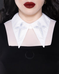 Gothic-chic sheer mesh top with long sleeves, bold embroidered cross designs on an extended pointy collar, soft stretchable fabric, a stylish back keyhole cut-out, and versatile color options, perfect for edgy streetwear, club outfits, and festival-inspired fashion statements.