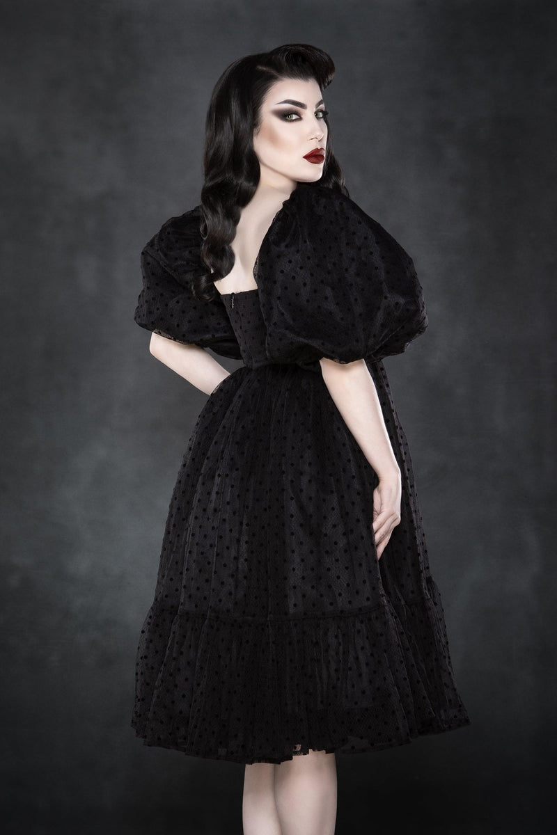 An ethereal, layered polka-dot dress featuring soft chiffon fabric for ultimate volume and movement. The empire waist and square neckline highlight the figure, while the ¾ puff sleeves enhance the dress’s romantic and classic aesthetic. This fully lined, knee-length dress combines gothic sweetness with timeless charm, making it perfect for spring picnics, date nights, or cottagecore-inspired outfits. Crafted from high-quality chiffon and bengaline materials.