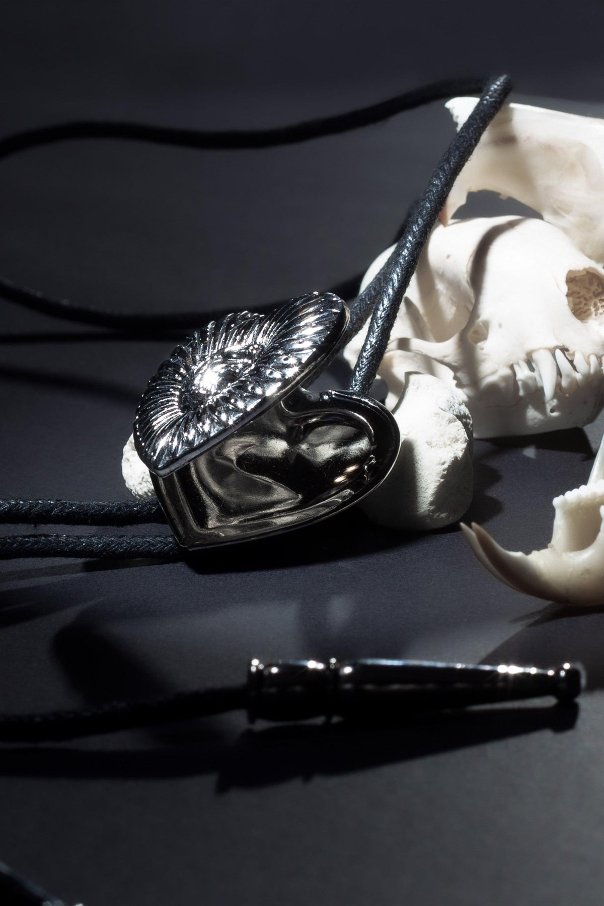 Elegant custom bolo tie featuring dual photo lockets for cherished memories, precision logo etching, and luxurious craftsmanship using fine materials, designed to capture the perfect blend of classic Western heritage and modern individuality.