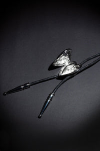 Unique artisan bolo tie with two customizable photo lockets, detailed brand logo etching, and premium craftsmanship, inspired by traditional Western fashion and created for individuals who appreciate bespoke accessories with emotional significance.