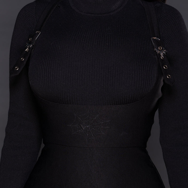 This black Webbed Suspender Skirt merges dark elegance with everyday versatility. Made of premium Bengaline fabric, it hugs the figure while offering stretch and comfort. Signature design elements include adjustable shoulder suspenders, a unique web buckle accent, and a subtle embroidered web motif at the waist for a sophisticated gothic finish. The concealed back zipper completes this modern, flattering silhouette.