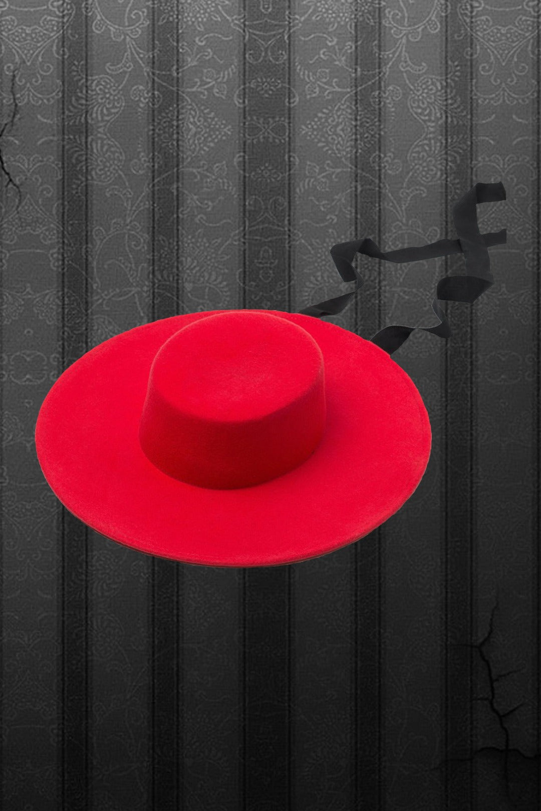 A red, wide brimmed wool hat with a black ribbon against a pin stripe background.